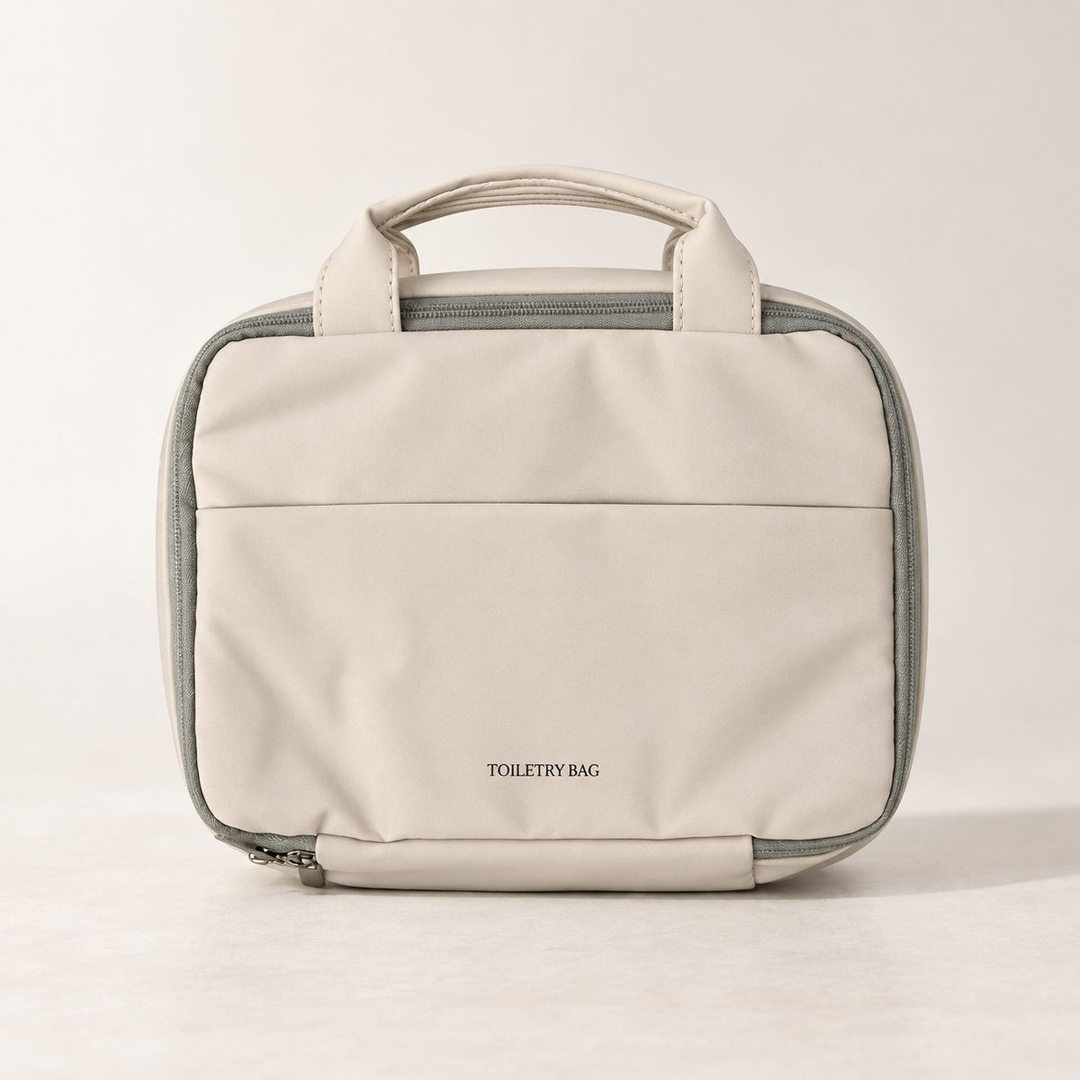 Closed warm beige hanging toiletry bag with carry handles and front pocket