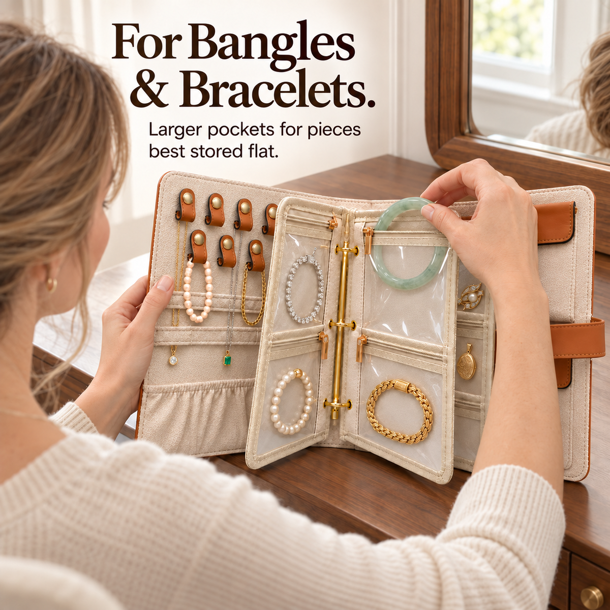 Woman placing a green bangle into a clear zip pocket beside stored bracelets in an open jewelry book.
