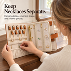 Woman adjusting a necklace in an organizer with leather hanging loops, retaining straps and a lower pocket.